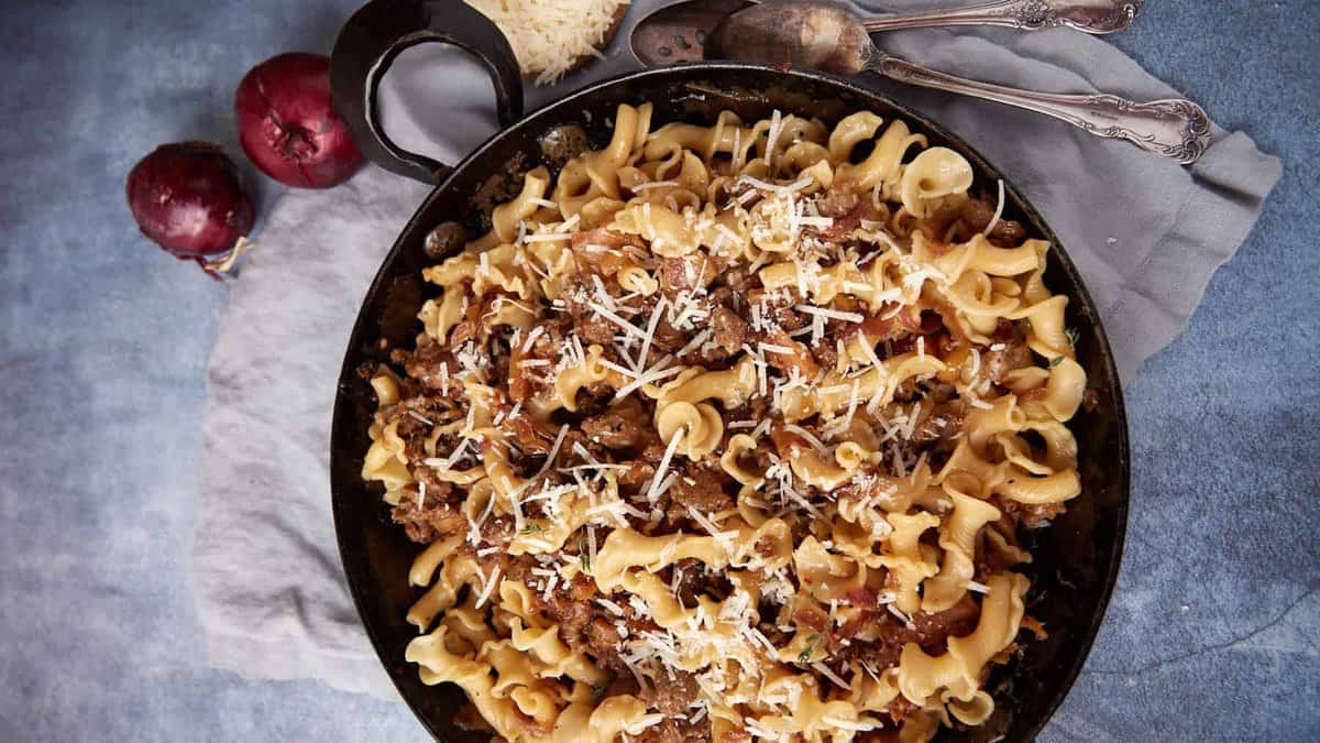 A bowl of pasta with Italian sausage.