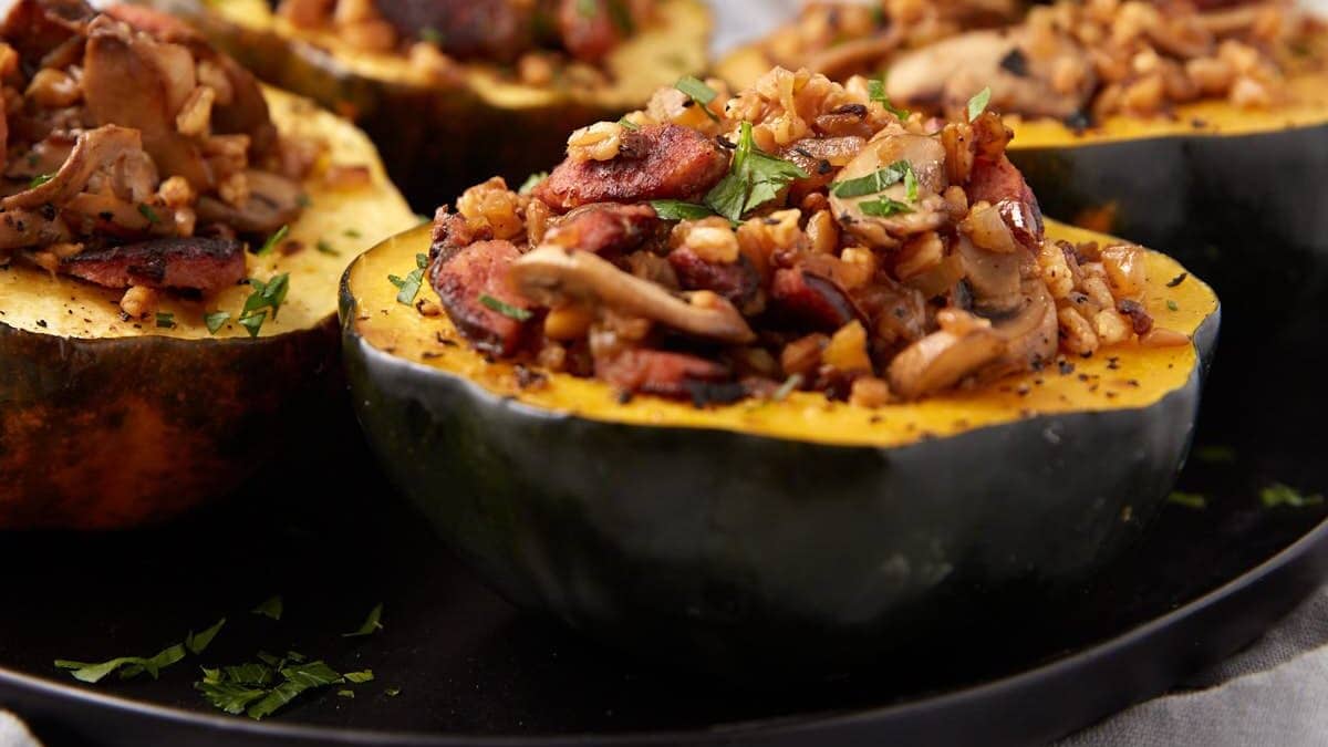 stuffed acorn squash halves on a plate.