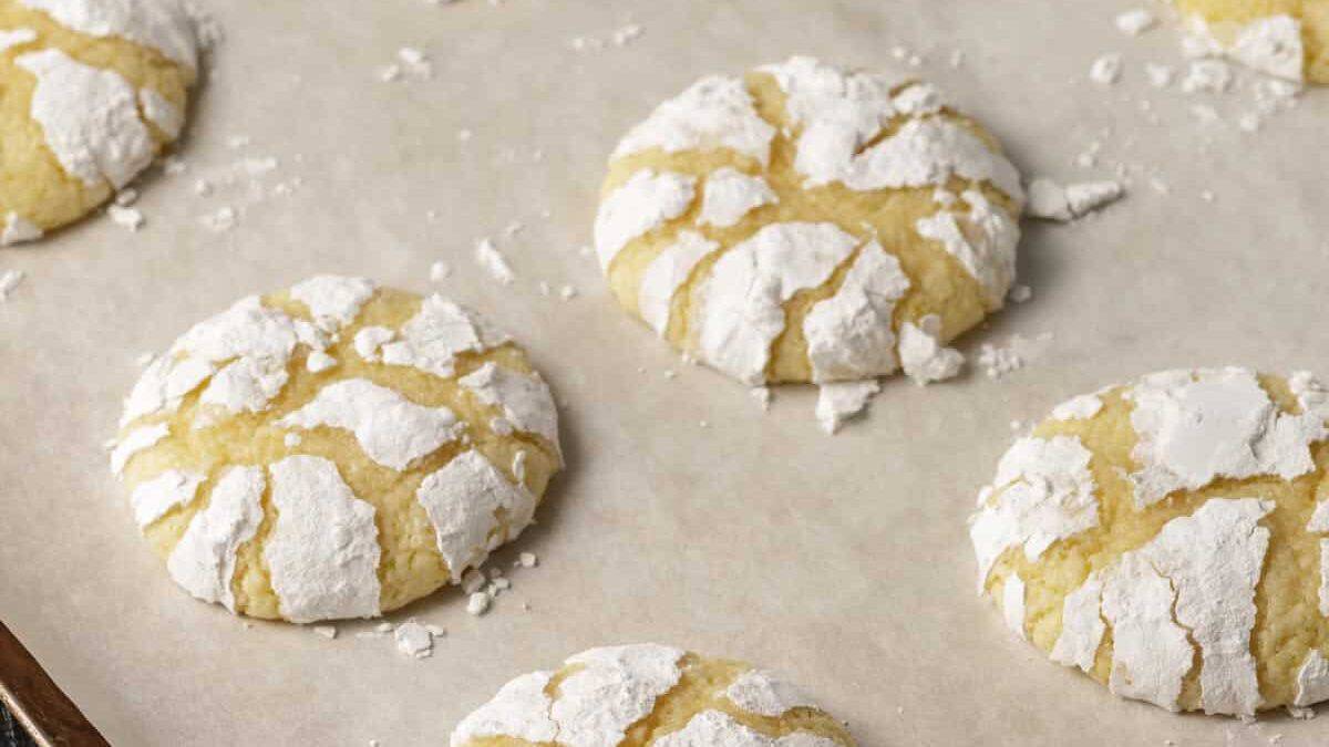 A baking sheet of baked lemon snowflake cookies.