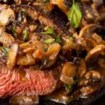 A black platter of steak marsala