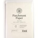 A package of King Arthur Baking Company Parchment Paper, value pack with 100 half-sheets (18" x 13"), perfect for Dutch Oven Bread, with product details printed on the front of the white packaging.