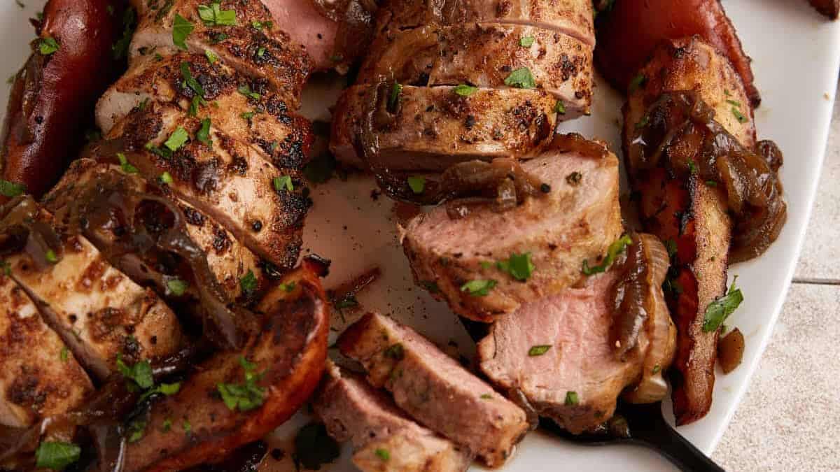 A platter with oven roasted pork tenderloin with pears. 